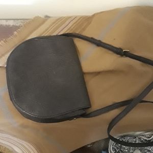 Small, black tooled-leather bag